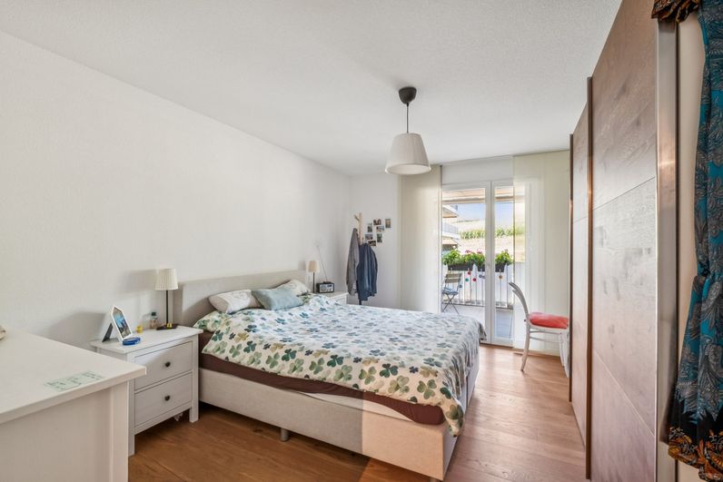 Schlafzimmer der 3½-Zimmer-Eigentumswohnung in Safenwil mit Zugang zum gedeckten Balkon